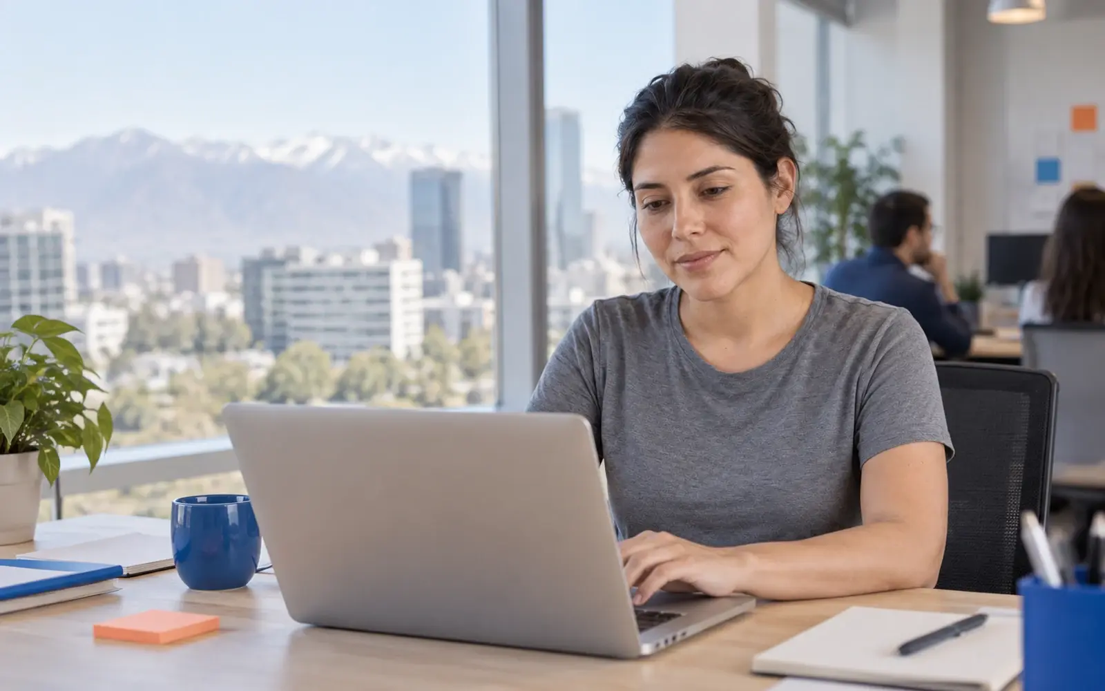 A person works on a laptop in a technology office.